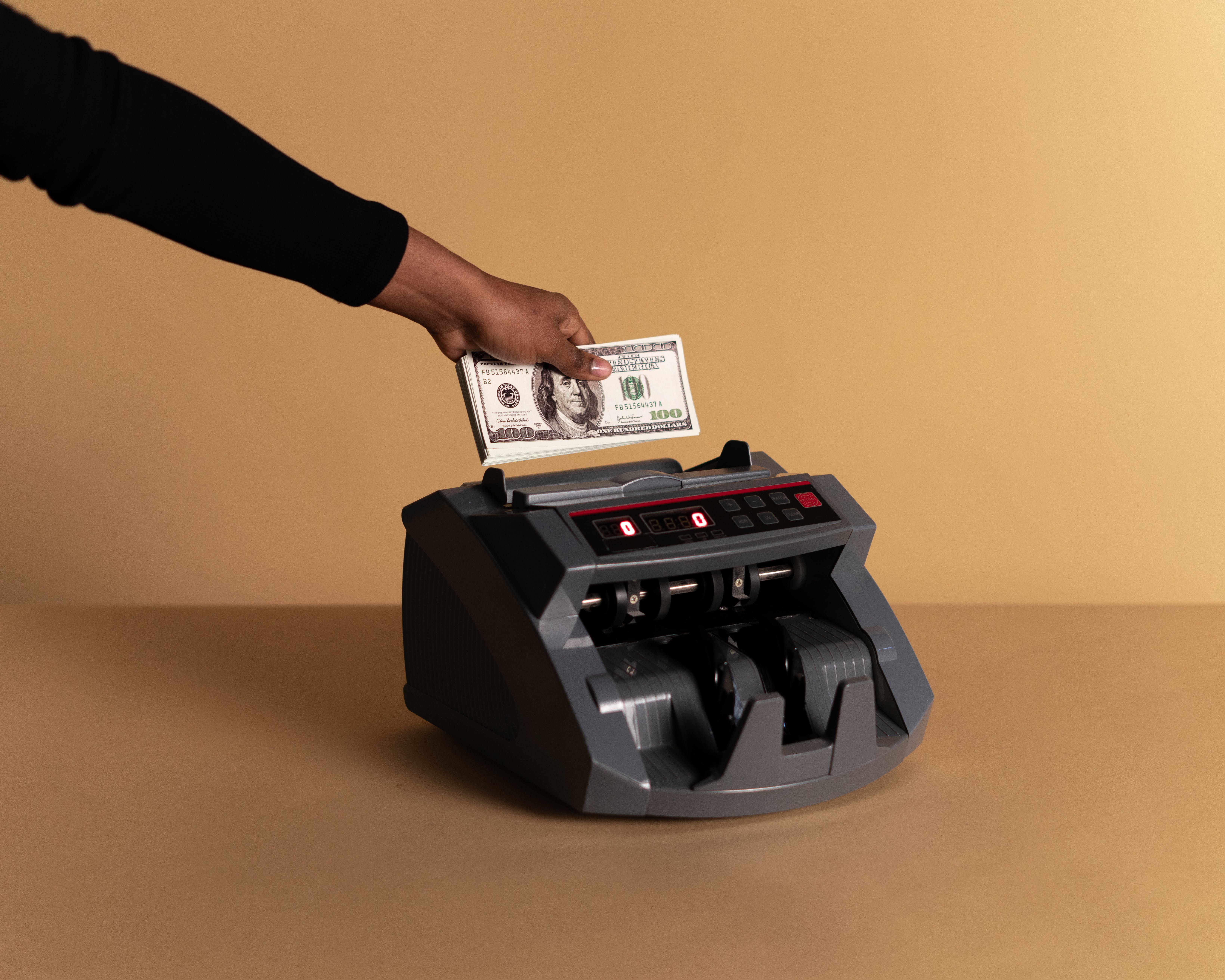 hand placing money in counter